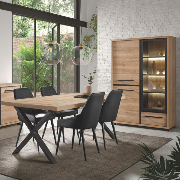 Salle à manger Rico (bi-ton Arizona Oak & Nero), vitrine LED allumée et table à manger pieds X en ambiance salle à manger